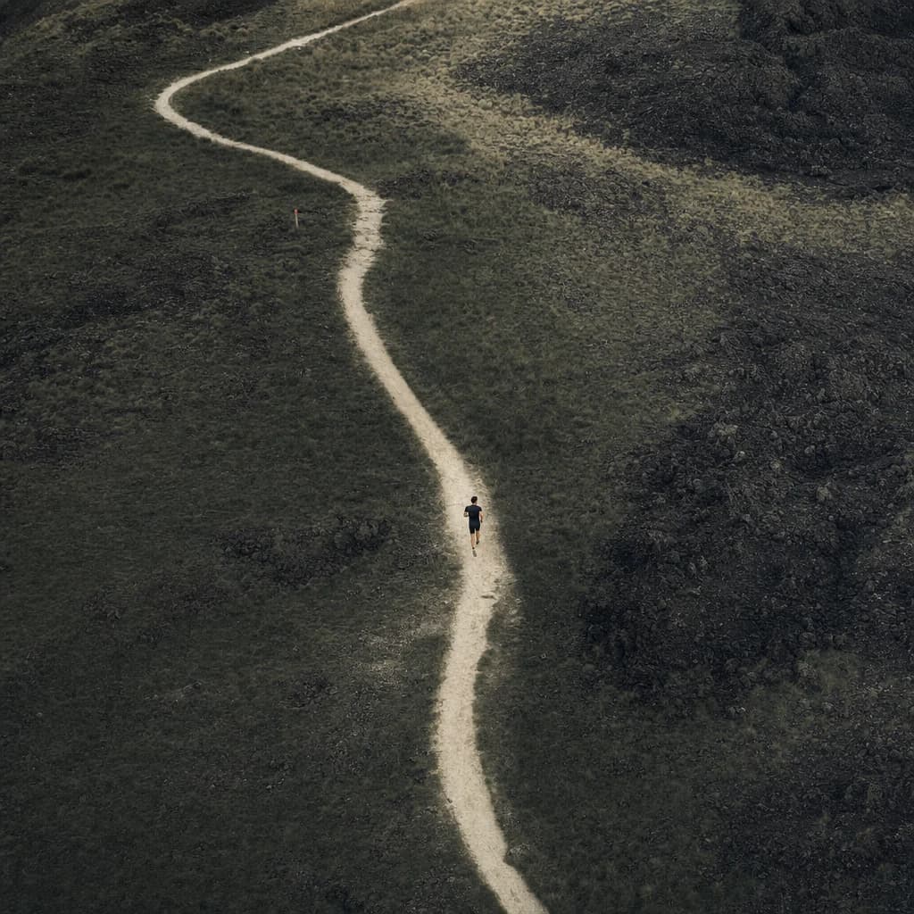 A small runner moving through a winding natural trail
